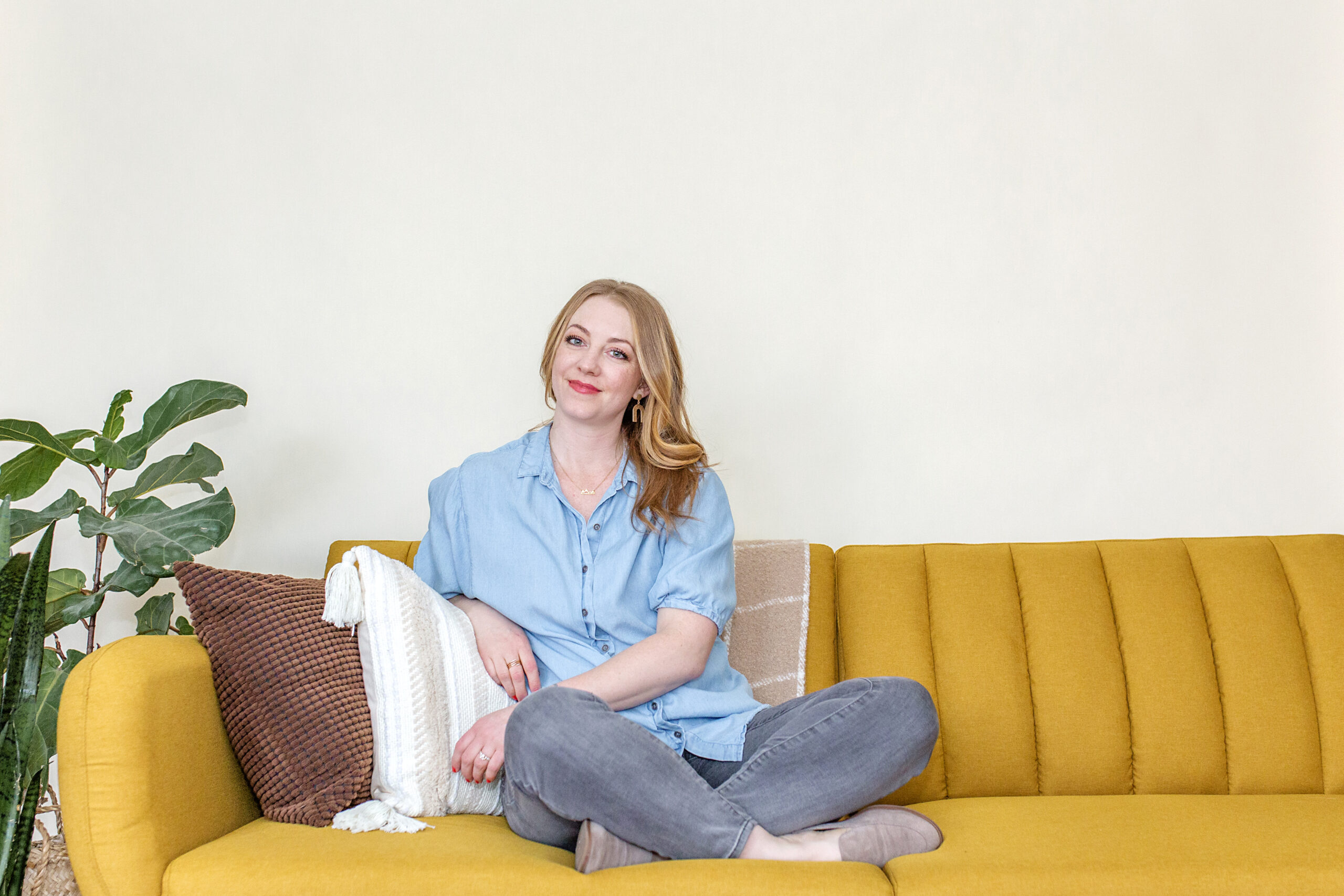 krysteena wilson sitting in a mustard couch therapy office decor blog post